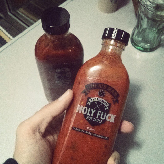an unopened bottle of  sauce is shown next to another bottle of  sauce