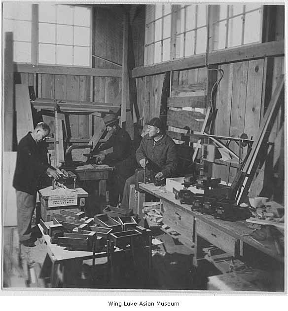 vintage black and white po of men in a woodworking shop