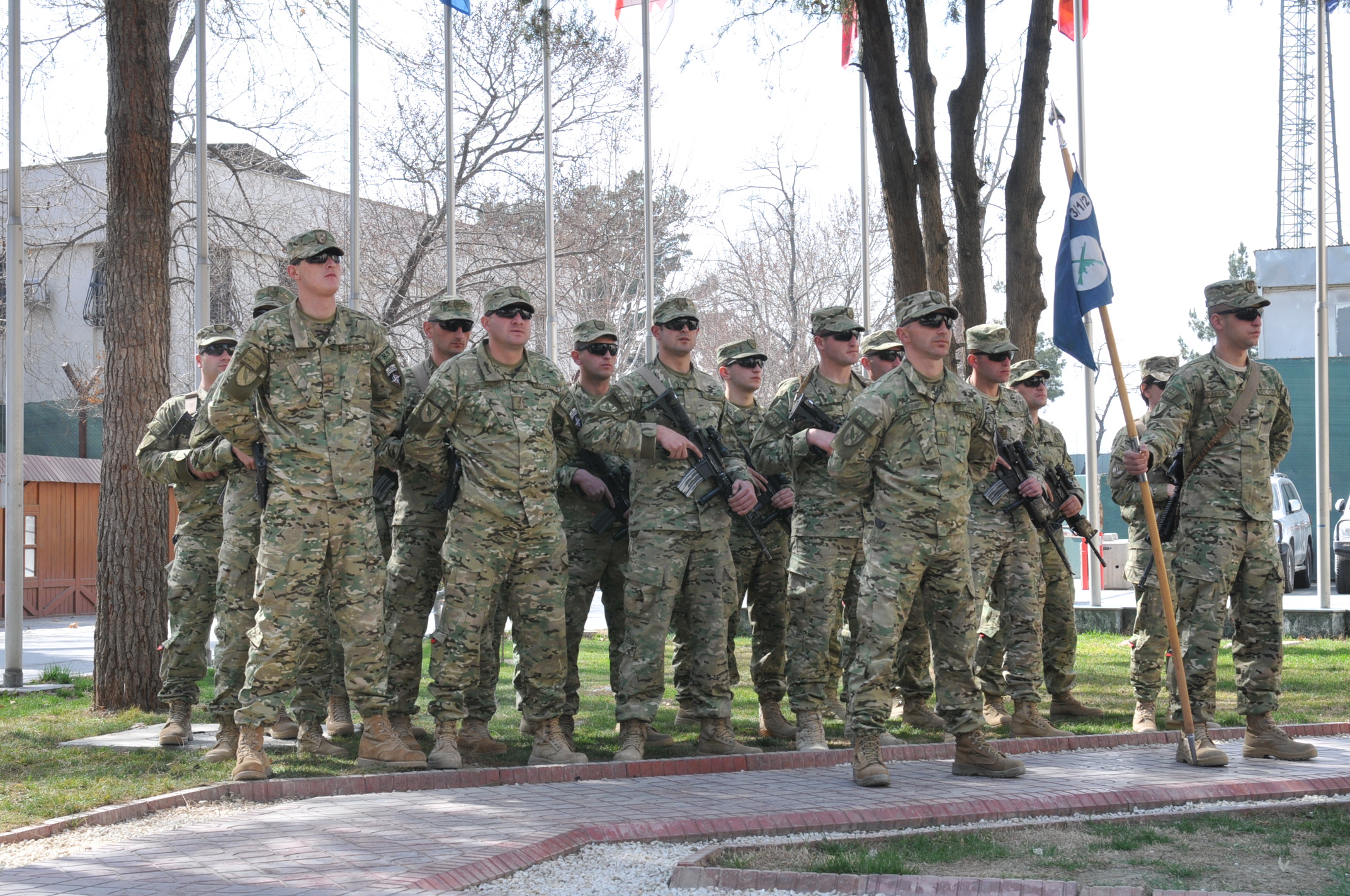 several soldiers in uniform standing together and posing for the camera