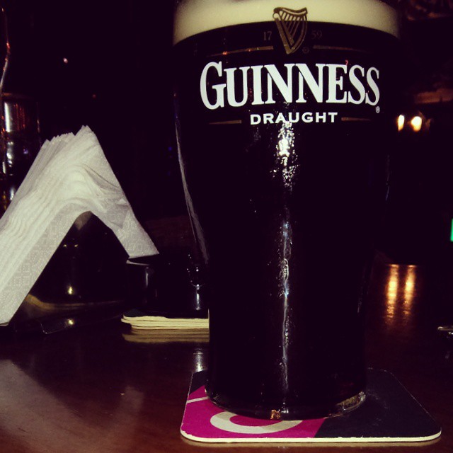 a glass on a table filled with beer