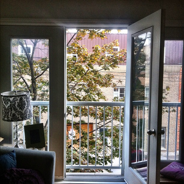 a large open window sitting next to a wooden floor