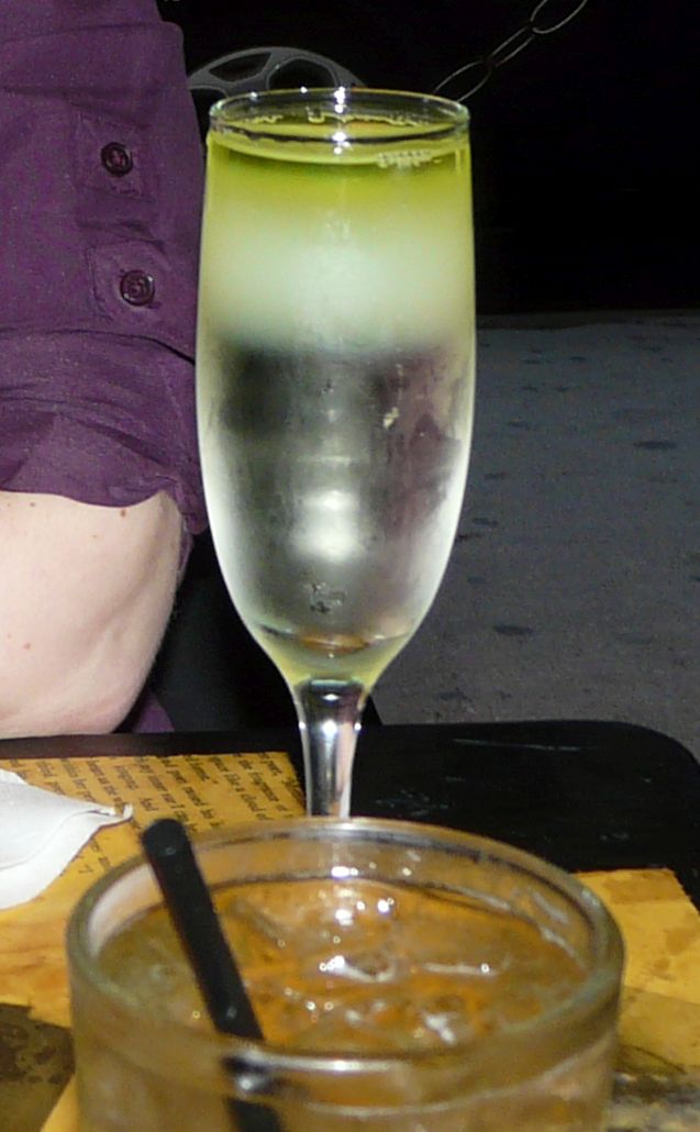 a person sitting at a table with a glass in front of it