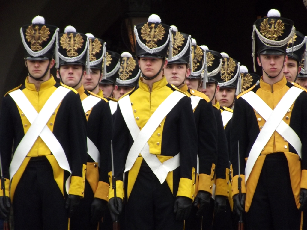 military soldiers standing in line together and wearing black and yellow uniform