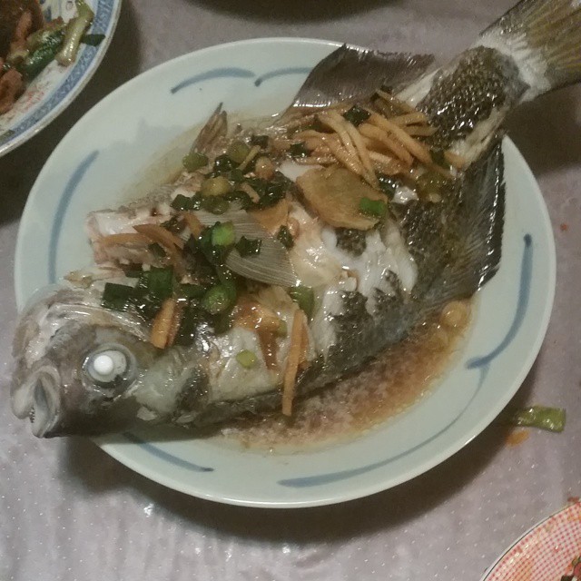 a dish of fish is displayed on a table
