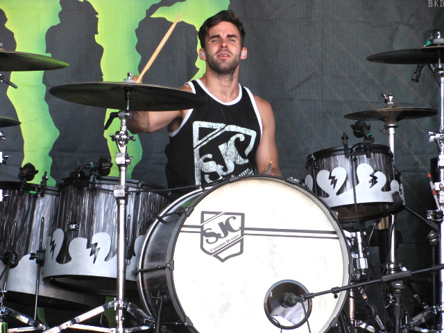 a man is playing drums on a stage