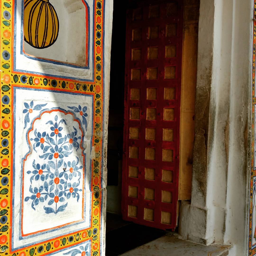 an open doorway with some decorative painted tile