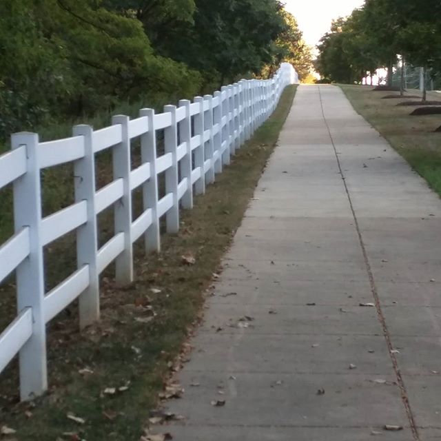 a white picket fence on a road