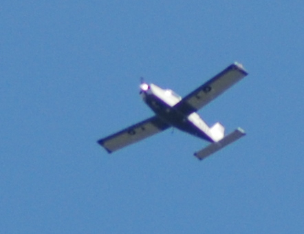 an airplane is flying through the blue sky