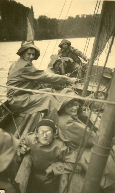 old pograph of men in sailboat with masks on