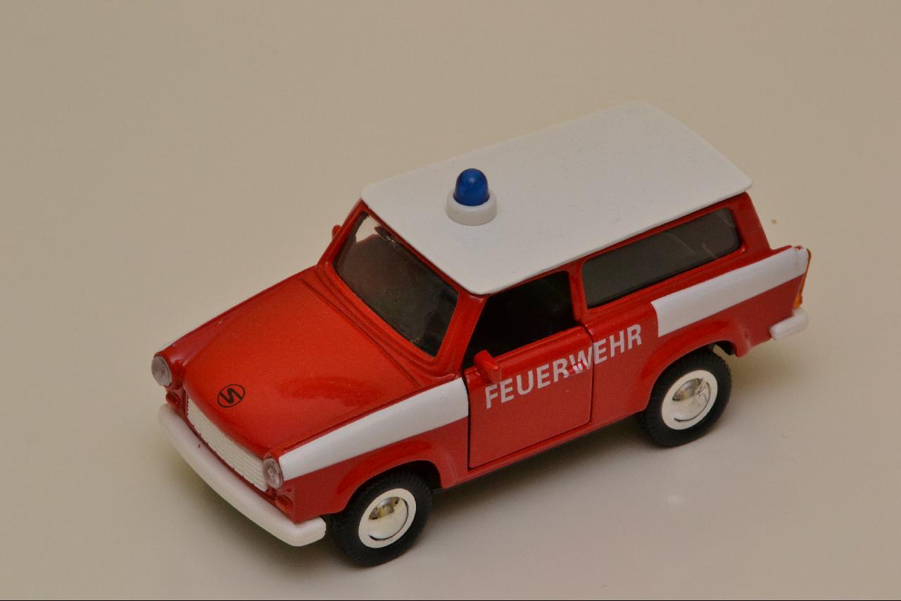 toy red and white truck with an emergency sign on top