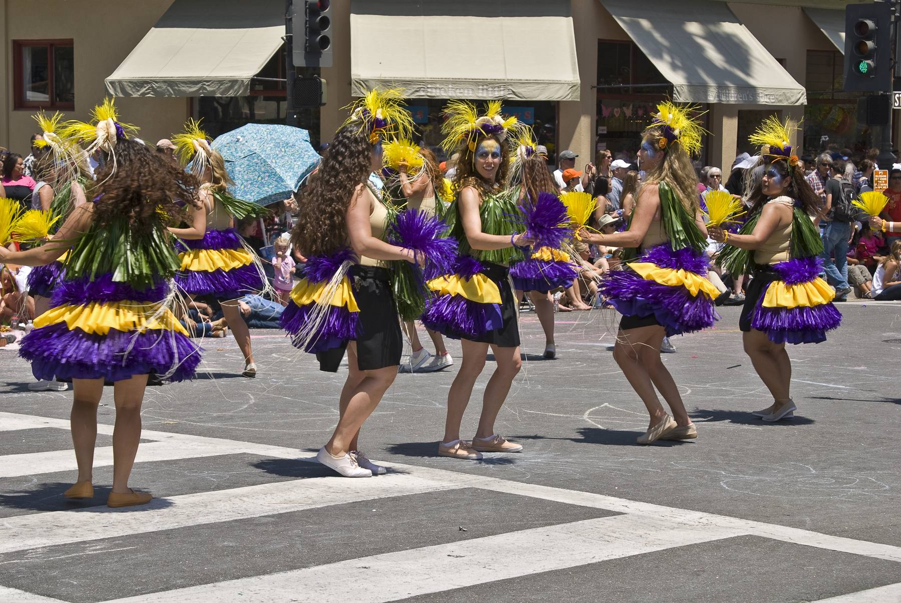 a group of women are dressed in purple and yellow outfits