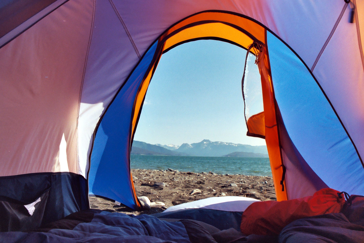 there is a view from inside a tent with the view of mountains