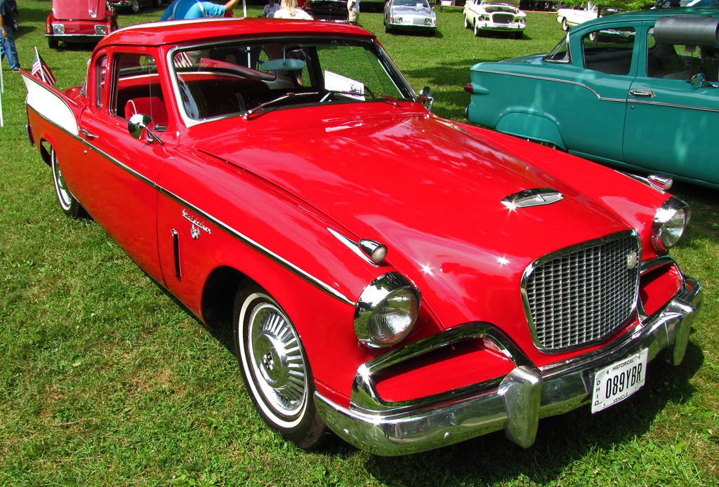 classic automobiles and people standing in the background