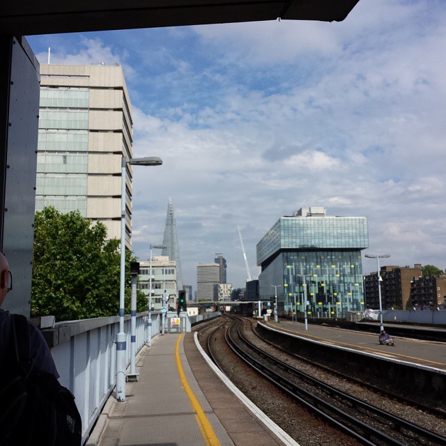 a man sitting next to a train platform