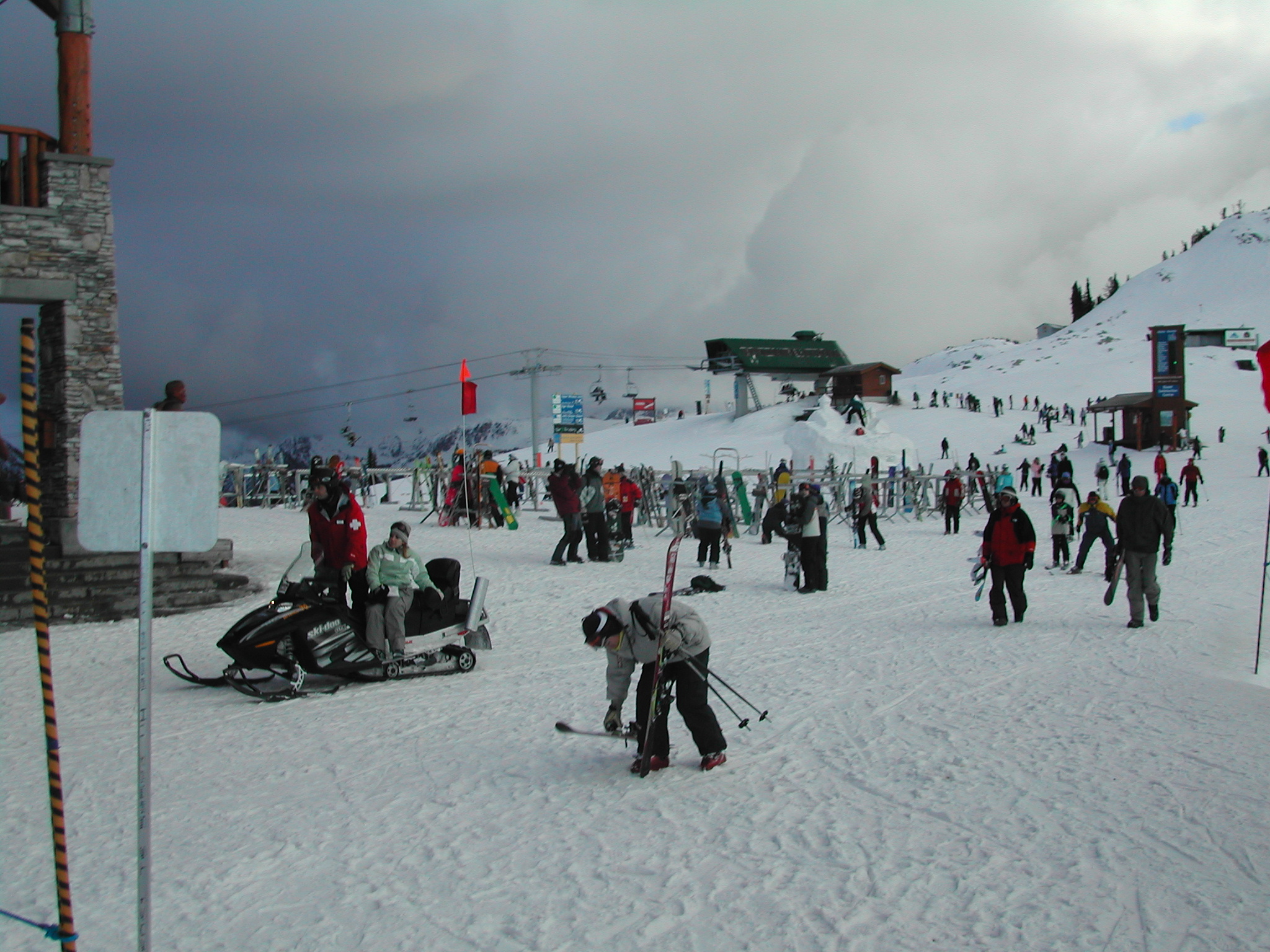 skiers gather on the snow with some of their gear