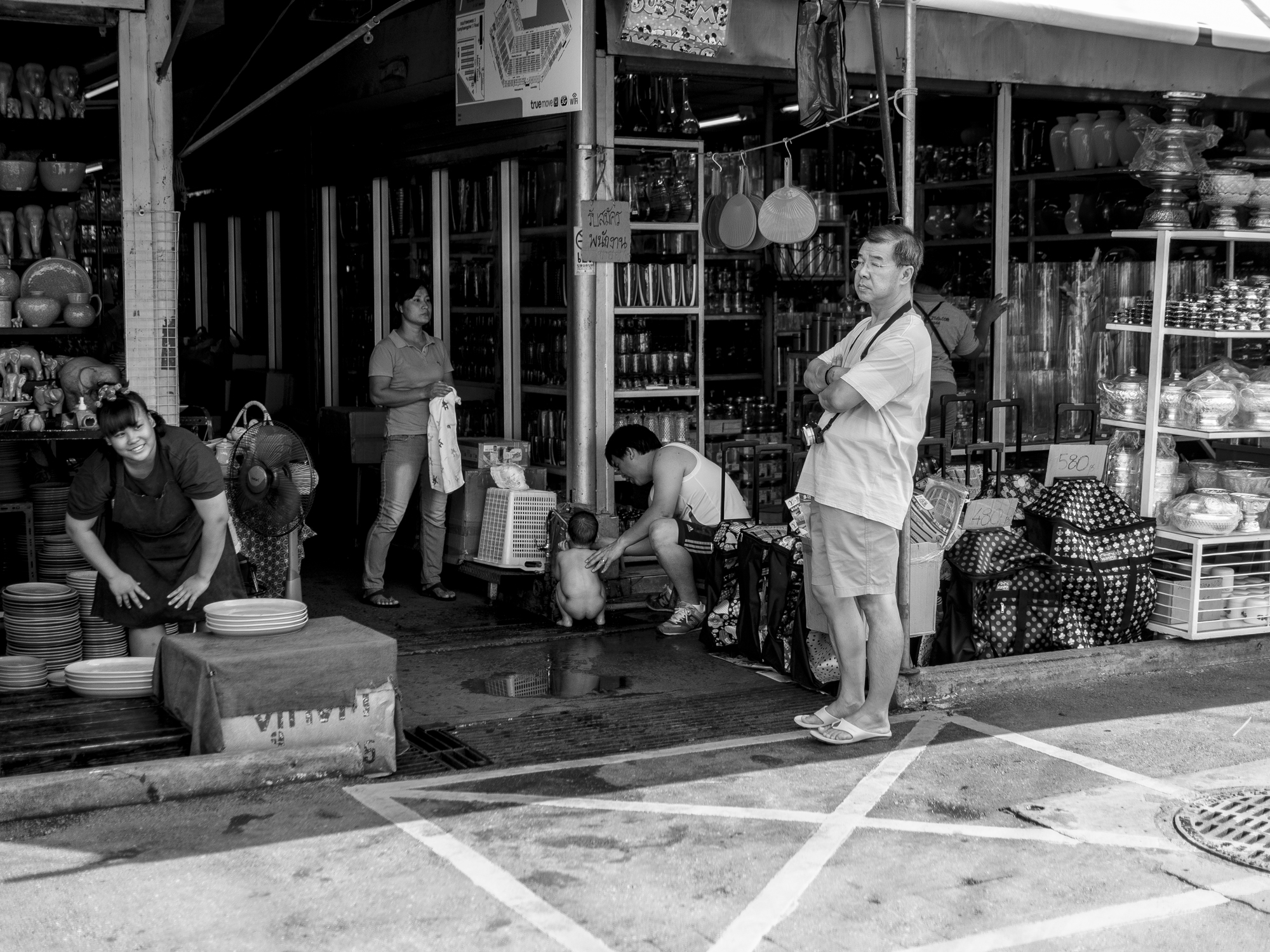 people in the market stand waiting for customers