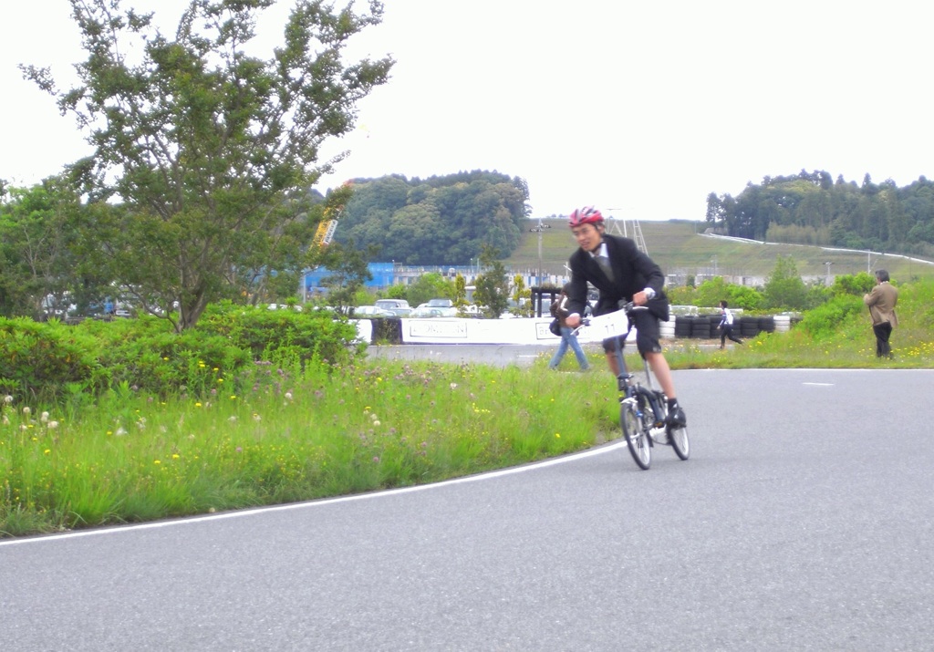 a man on a bike riding down the road