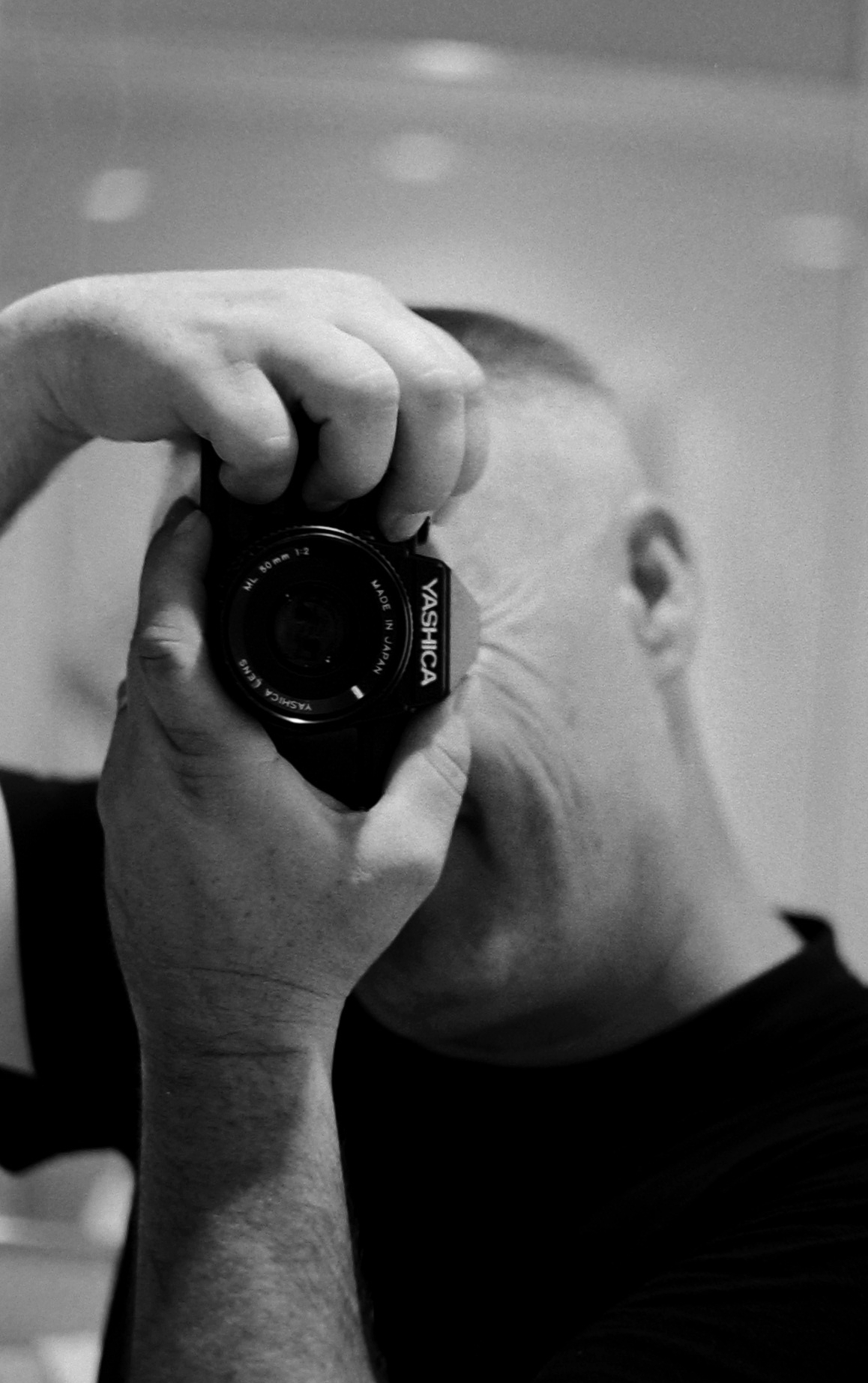 a black and white po of a man holding a camera