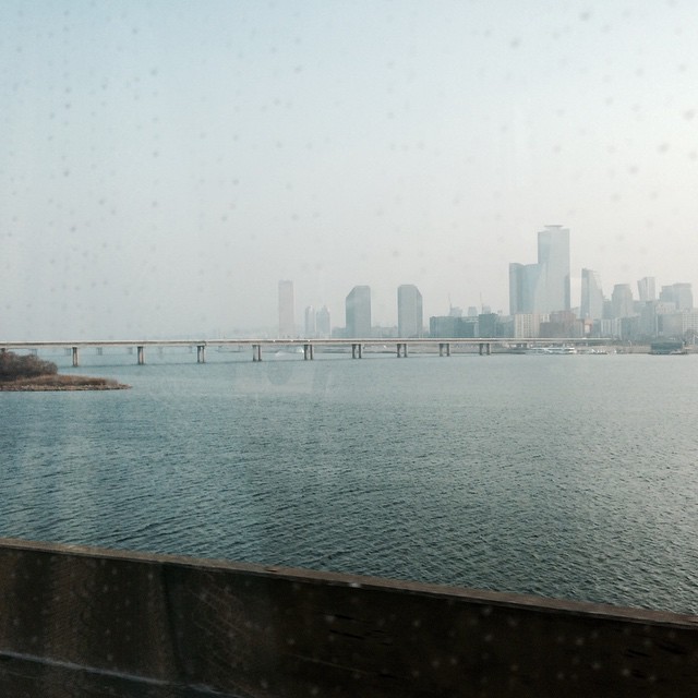 an urban view of a city next to a body of water