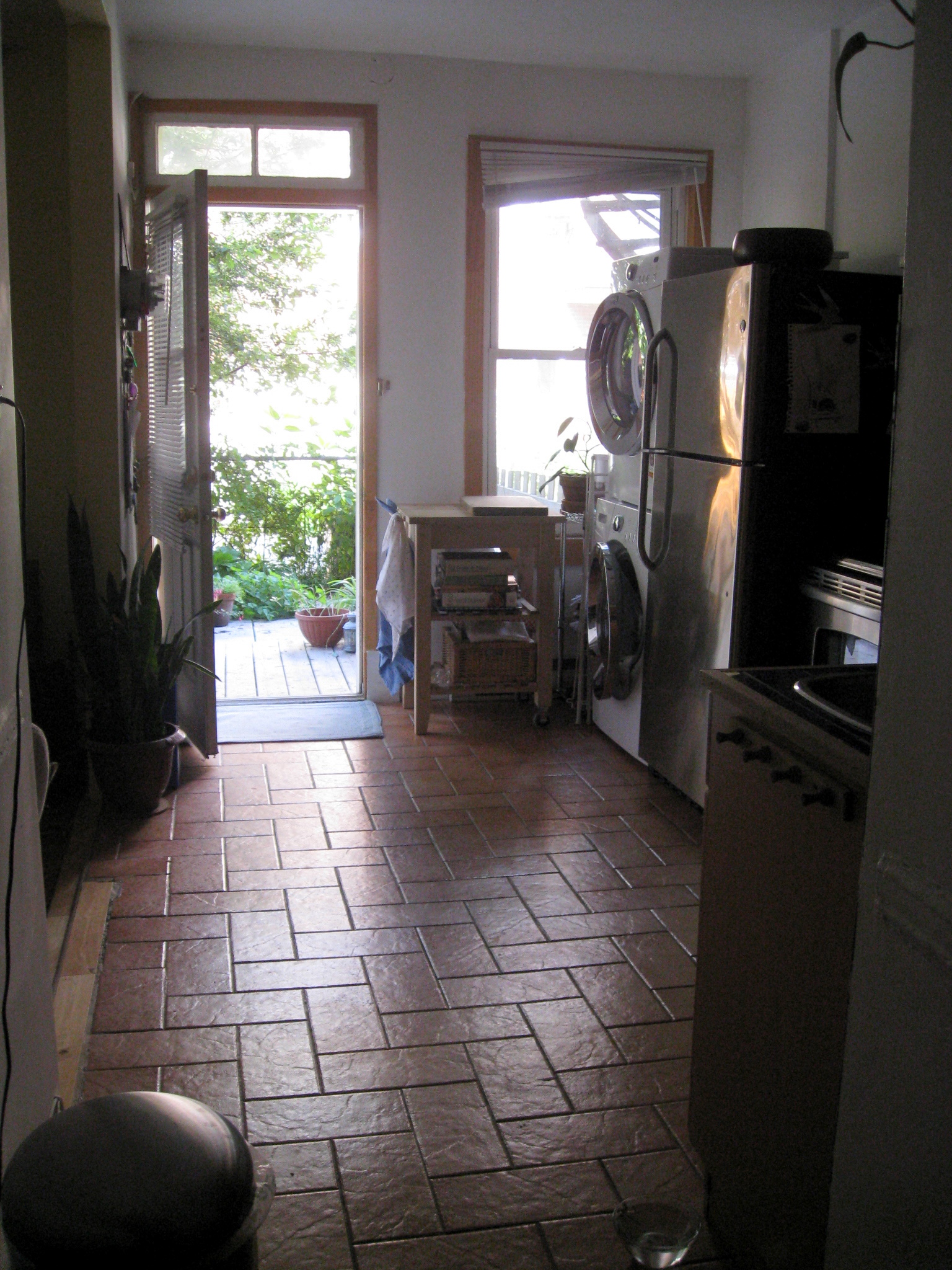 a living room that has brick tile flooring