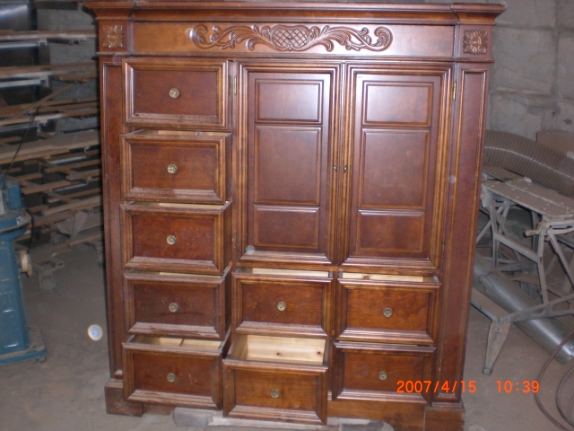 a large wooden cabinet with drawers in a warehouse