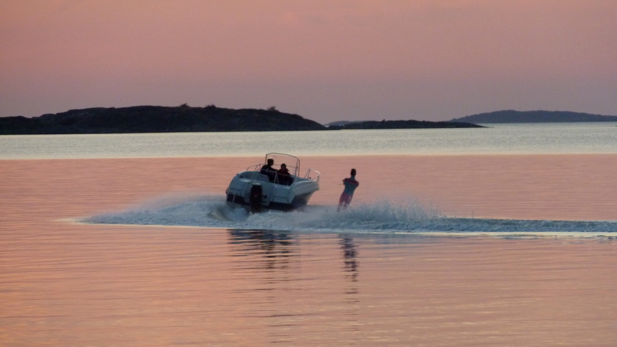 two people on a boat watercraft riding at the beach