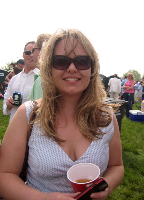a woman is at an event holding a beverage