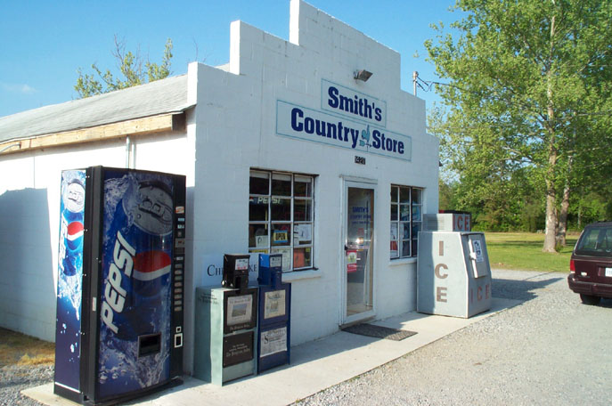 a white building with soda machines and vending machines in front