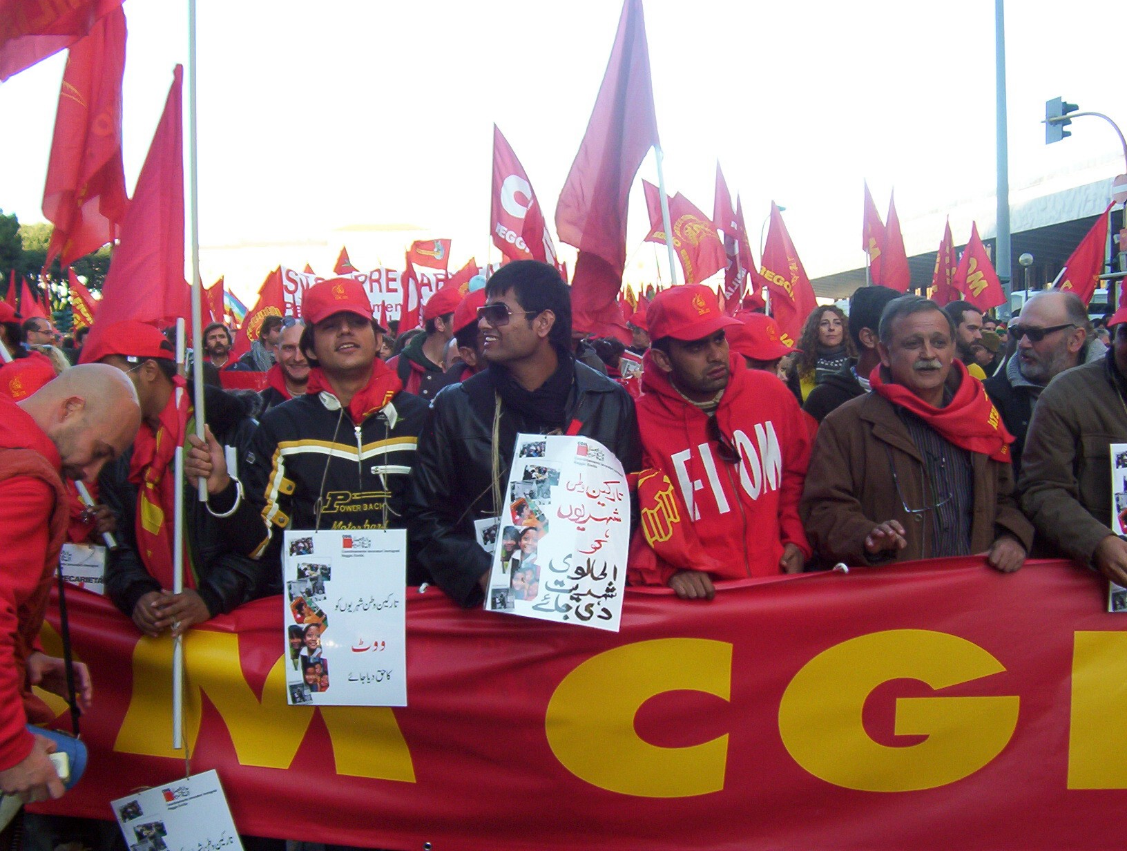 several people are protesting and holding signs in the same language