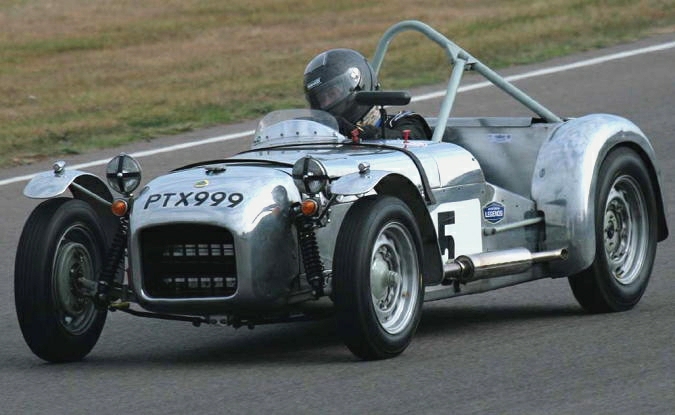an old silver race car that has been modified