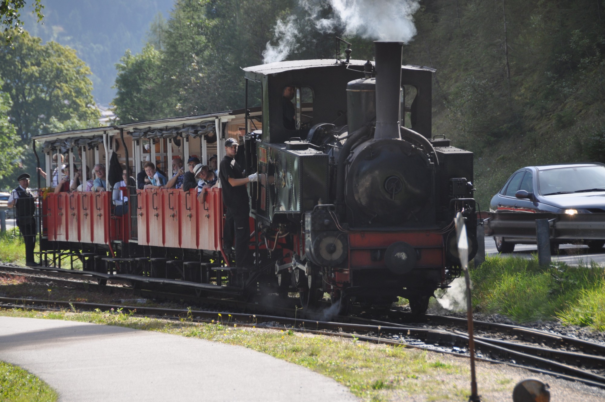 people riding a train as it is traveling down the tracks