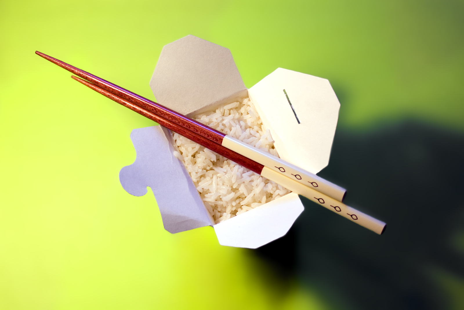 two chopsticks in a bowl of white rice