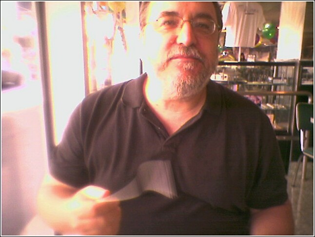 an older man holding up a knife and fork