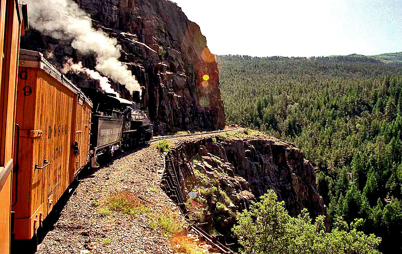 a steam train rolls down a mountain slope