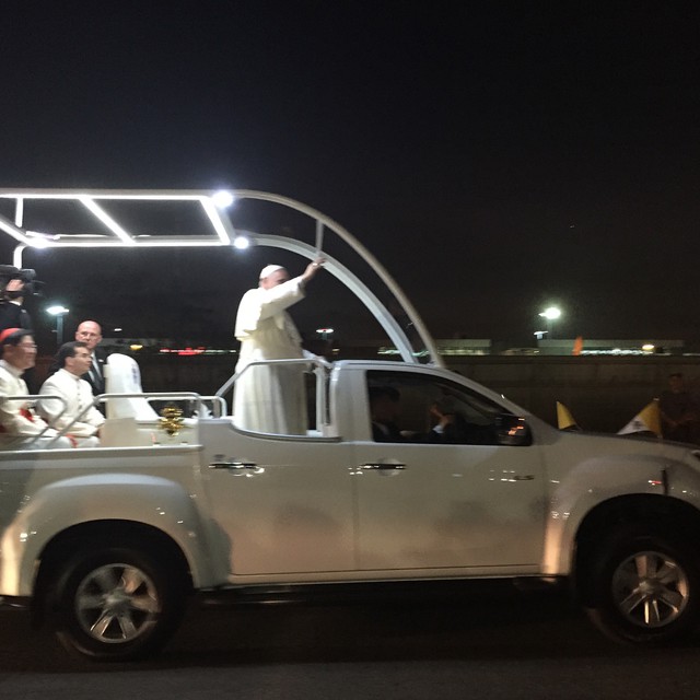 a man in a white outfit on the back of a truck