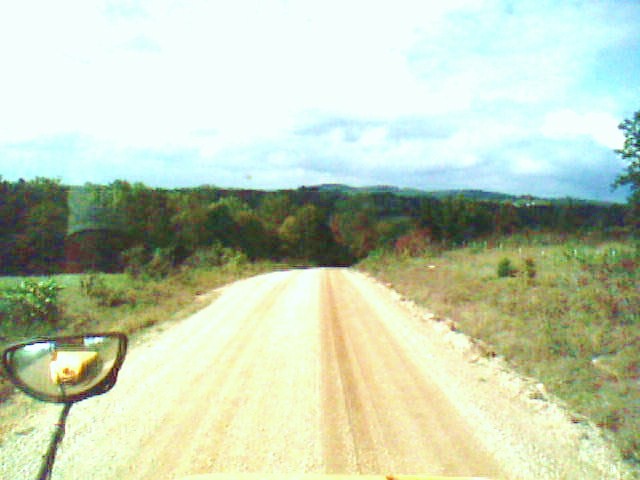 a vehicle is traveling down a dirt road