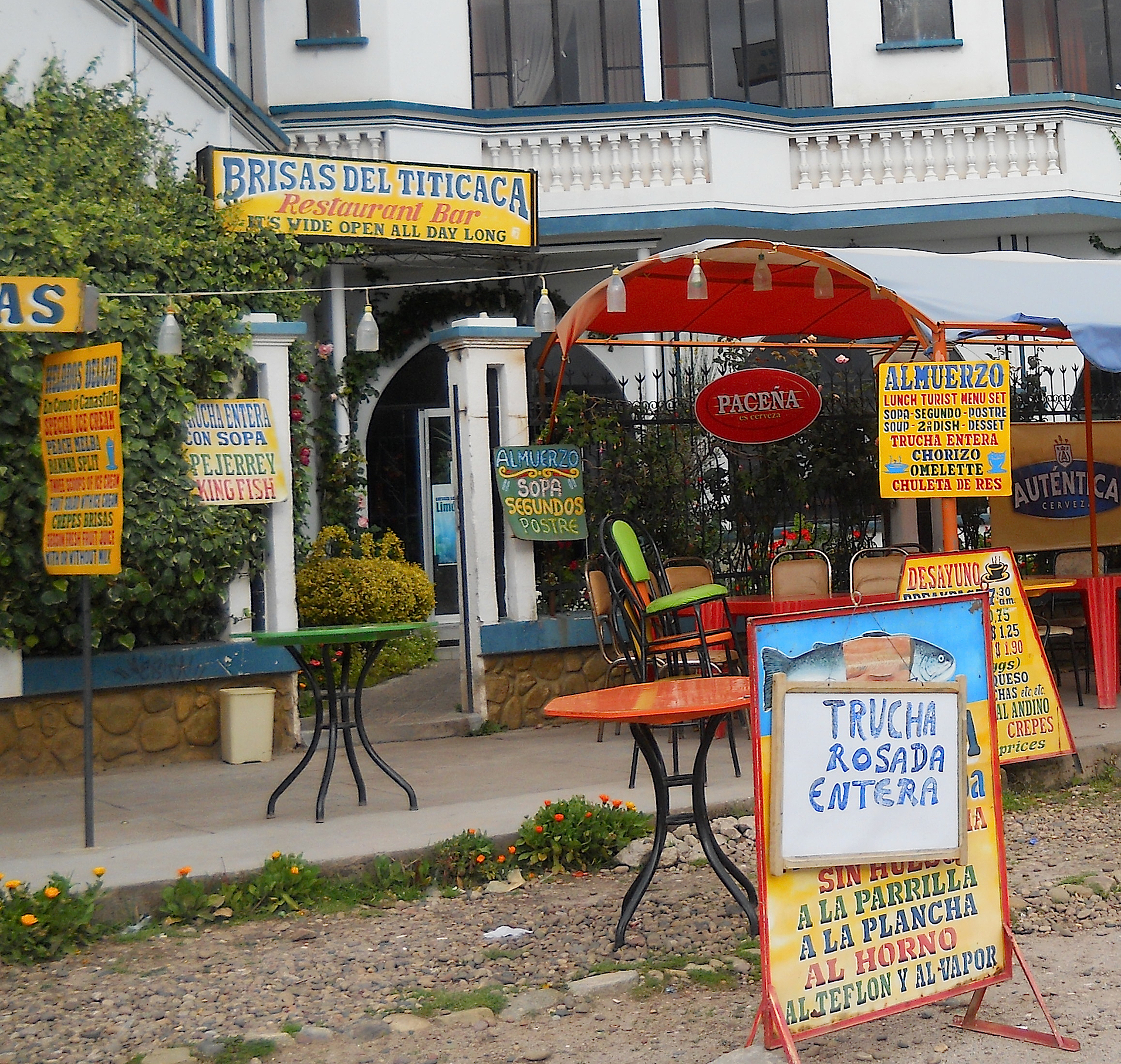the front of a restaurant with various signs outside