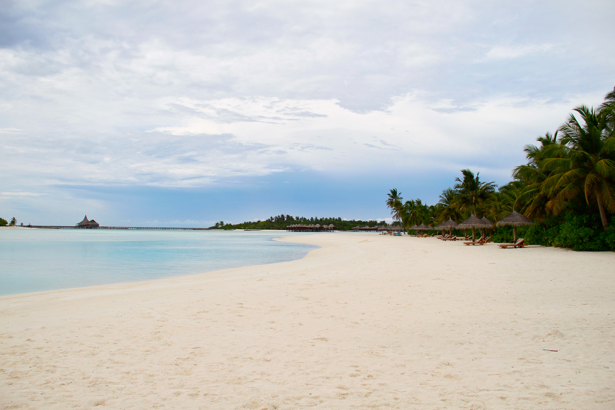 a deserted beach on an island with palm trees