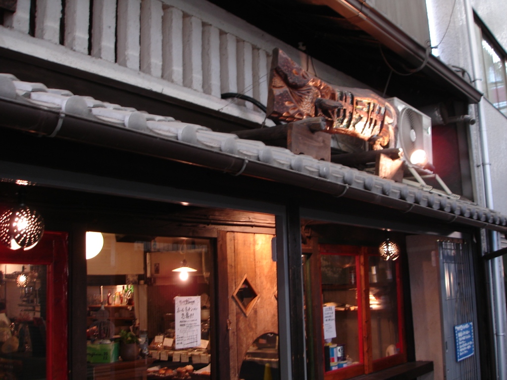 people are walking out the outside of an empty restaurant