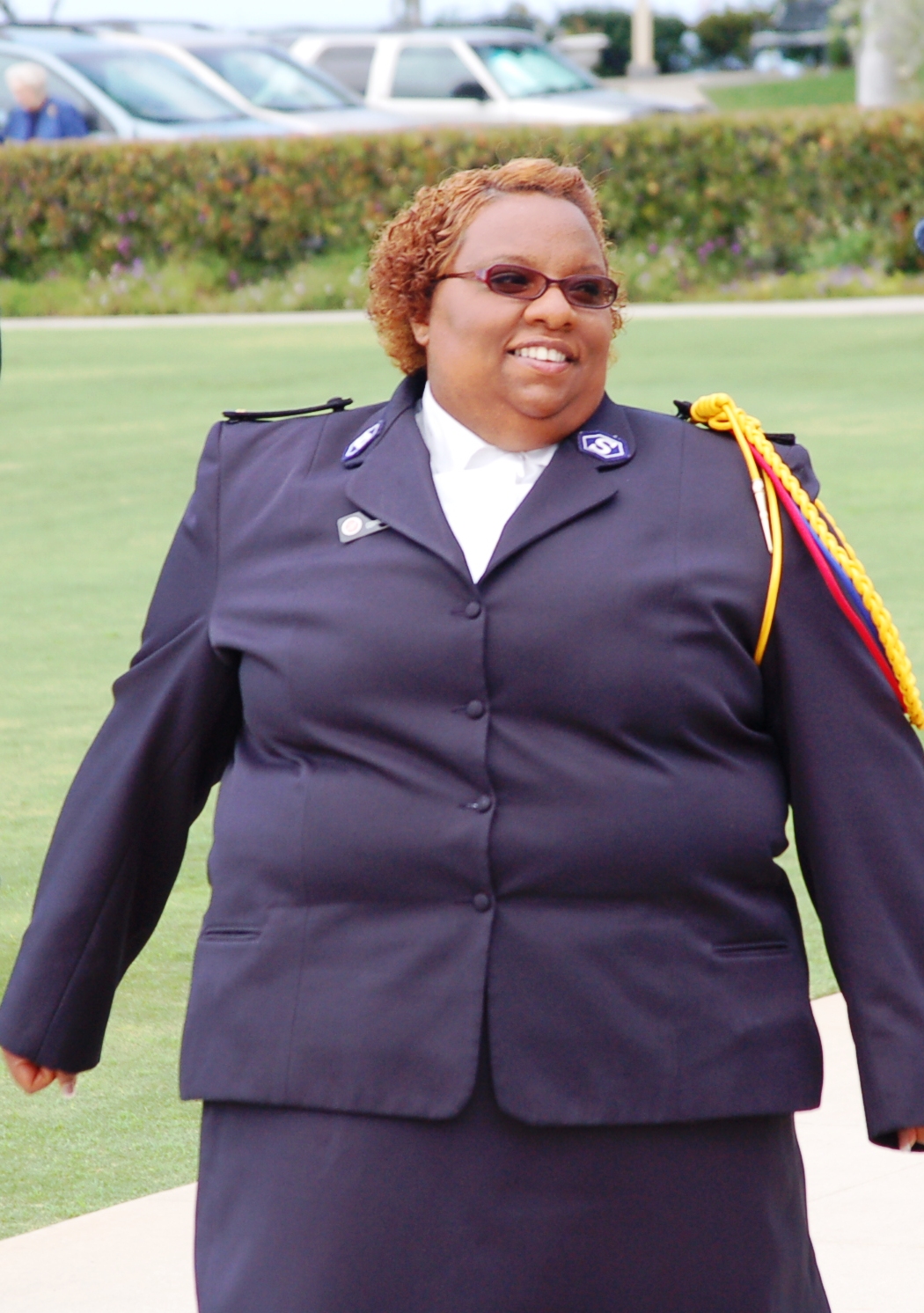 woman in black suit with white collar and sunglasses
