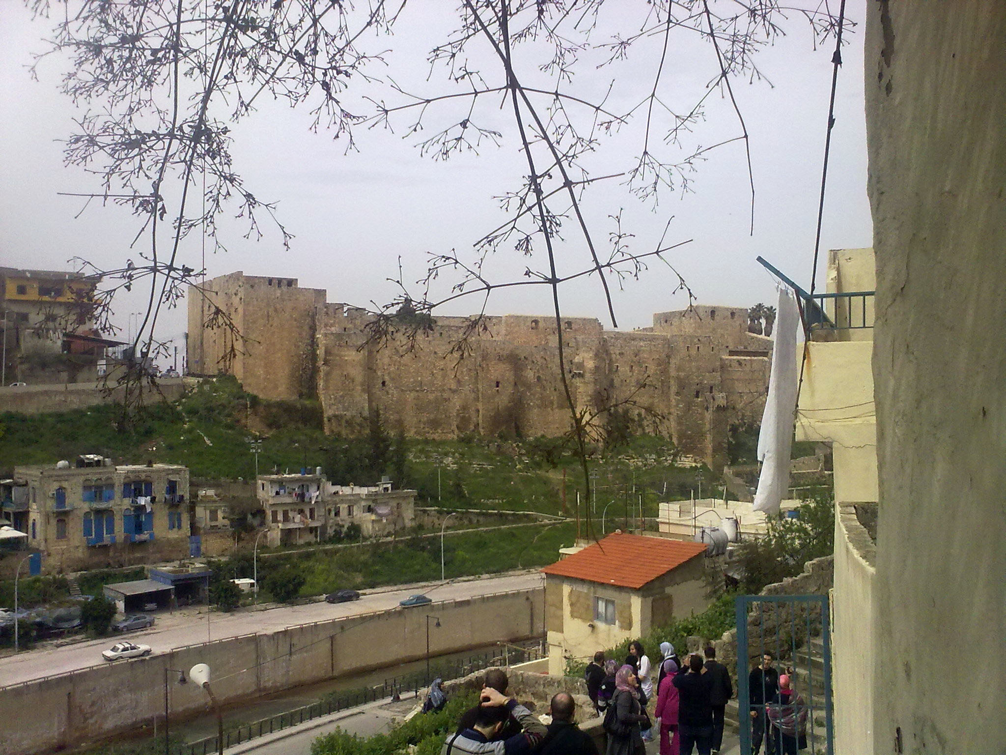 some people on a hill next to some buildings