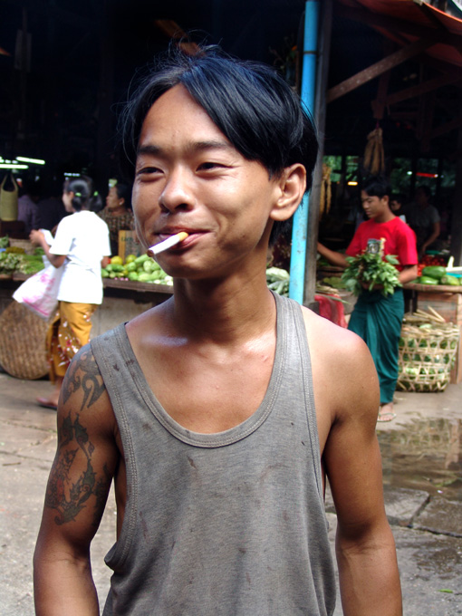 a man with an object in his mouth on a street