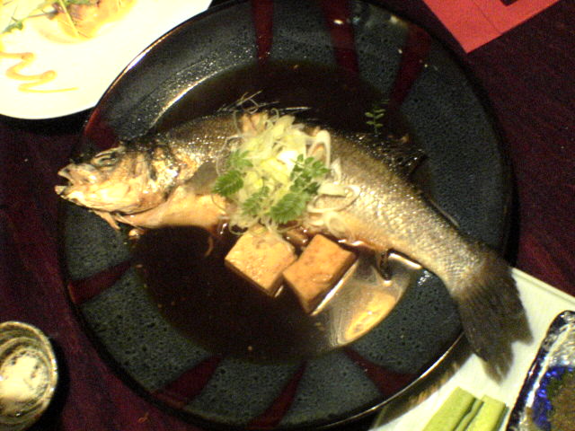 a big fish sitting on top of a plate