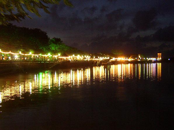 a river at night, with lights reflecting off the water