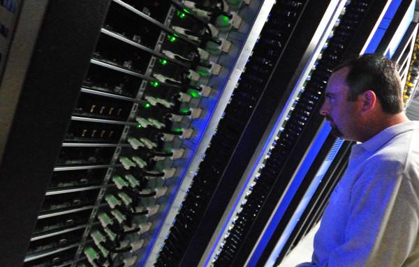 two men in the data center look at different servers