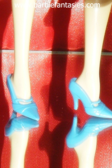 there are shoes that appear to be a doll's legs and feet