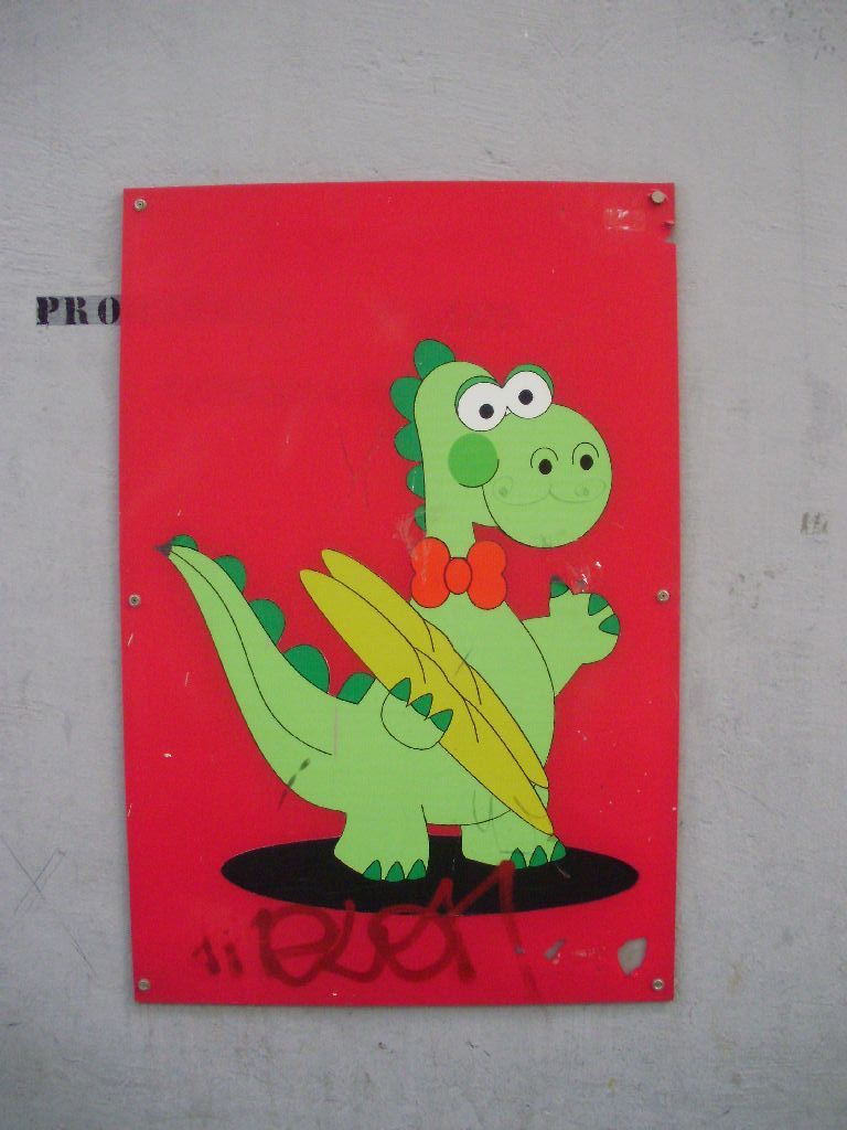a green cartoon dino with a bow tie