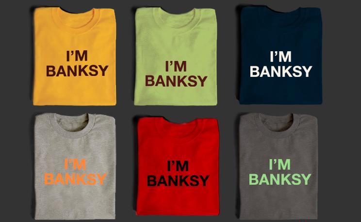 a row of t shirts with words saying i'm banksy