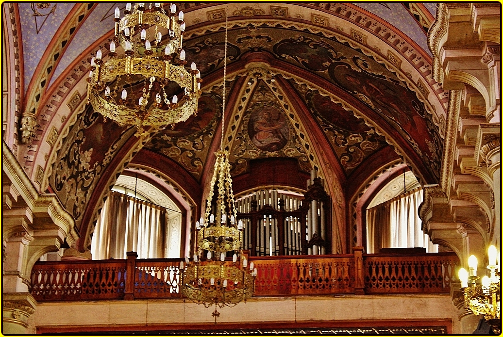 a beautiful church with a chandelier and organ