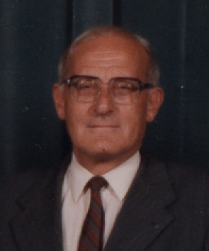 a man wearing glasses and a suit with a tie